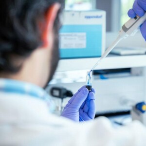 Looking over the shouldrer of a malr Keros Therapeutics scientist testing a sample in a lab